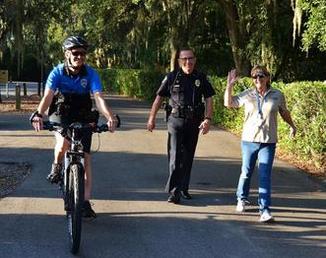 Officer on Bike and Officer and Official Walking